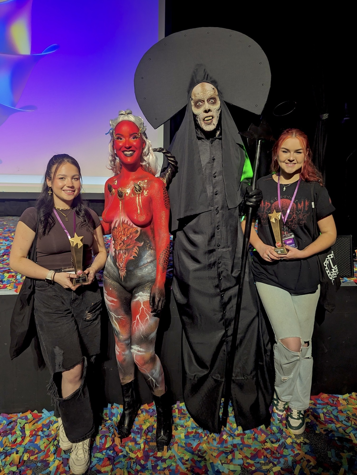 Two AUB BA (Hons) Make-up for Media and Performance graduates pose for a photo with their models after winning awards at The Prosthetics Event.