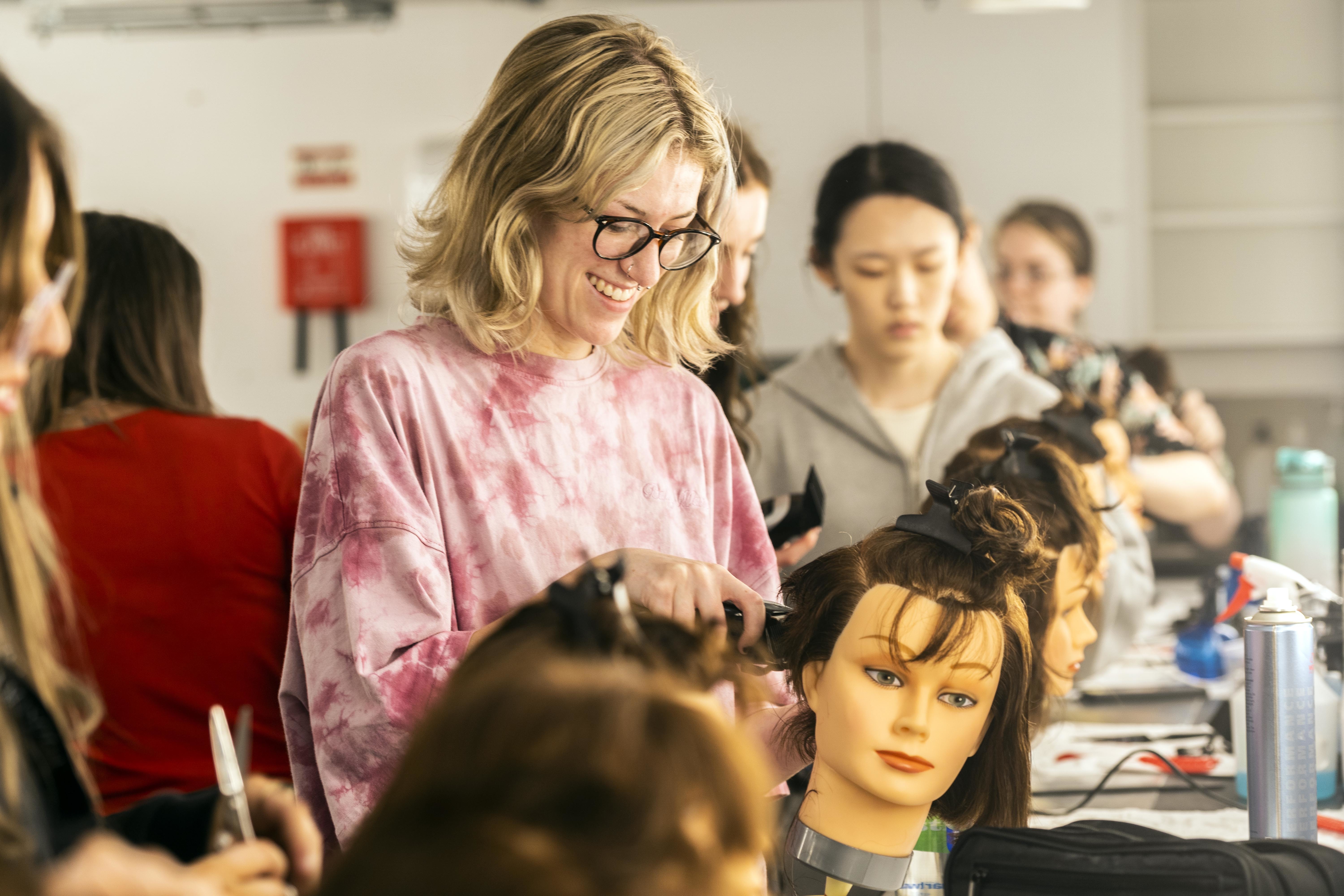 A student works on a mannequin in AUB's Make-up Studio