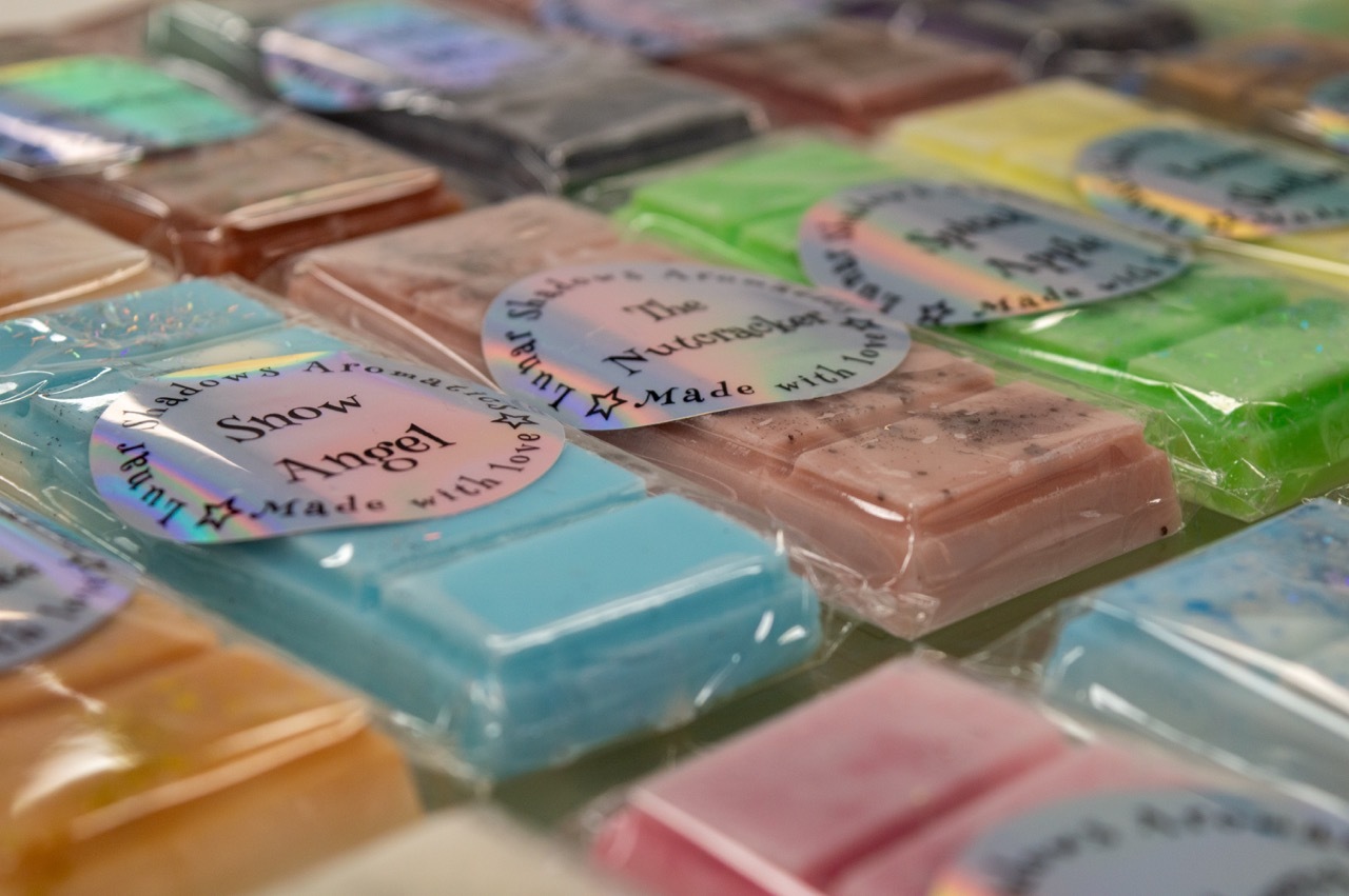 A collection of multicoloured soaps: blue, pink, green, yellow and orange.