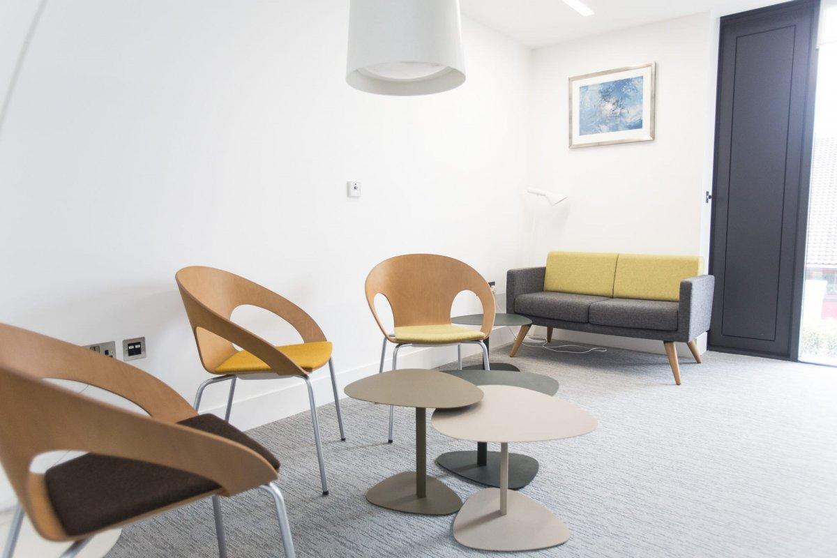 Meeting room within Student Services, features three chairs and a sofa