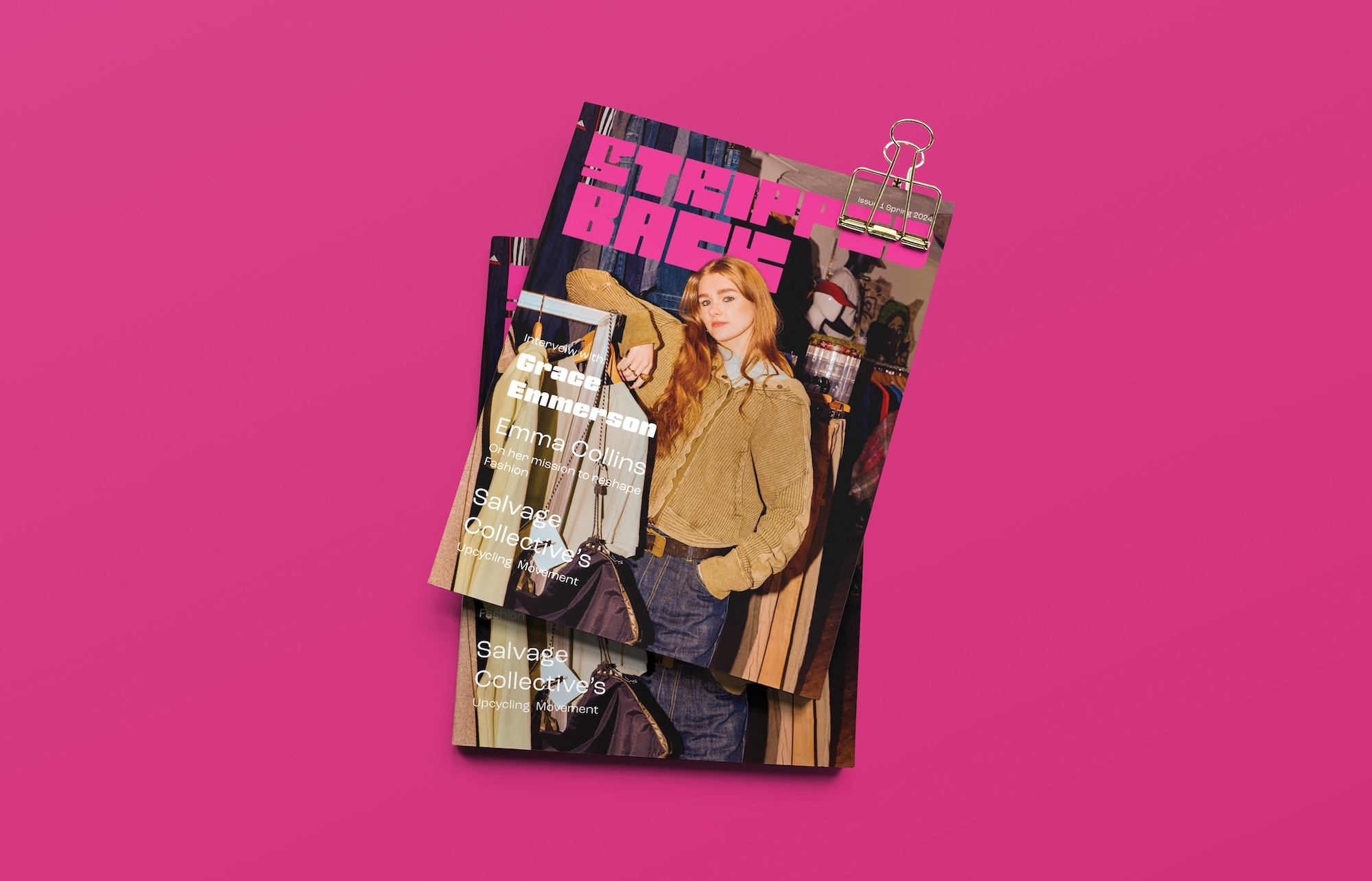 Stack of fashion magazines with blonde model on covers, clipped with gold binder clip against bright pink background.