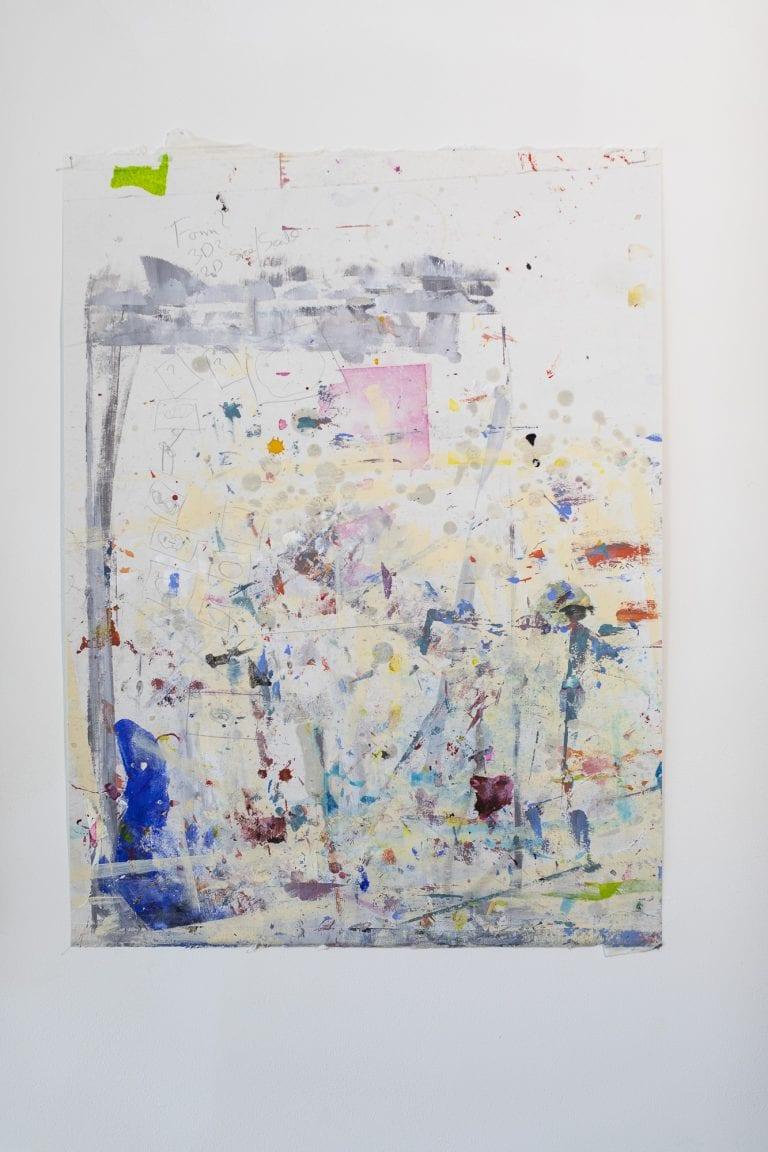 Abstract artwork hanging on a plain wall.
