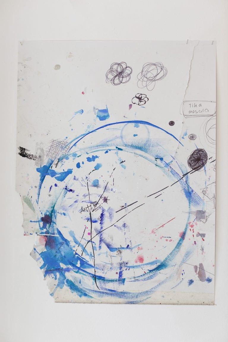 Abstract artwork made up of painted blue rings and hand-drawn black concentric circles.