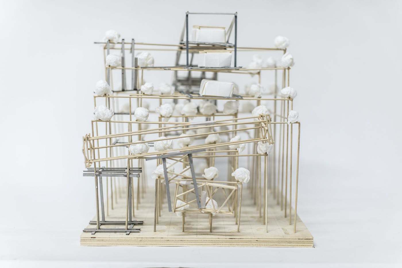 Architectural model of a multi storey building made of wooden and metal rods.