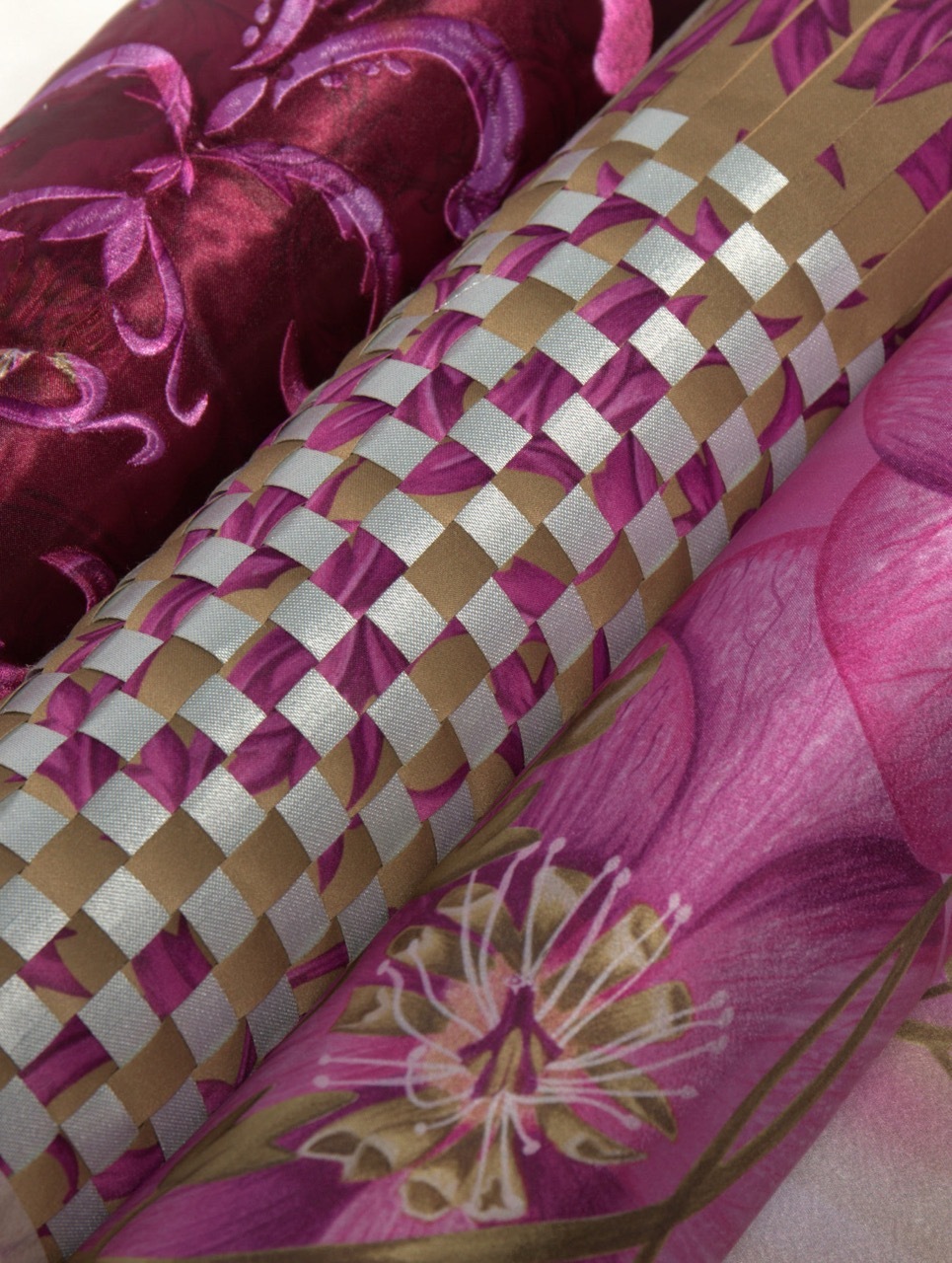 Woven basket with purple, gold and cream checkered pattern surrounded by purple leaves and floral fabric.