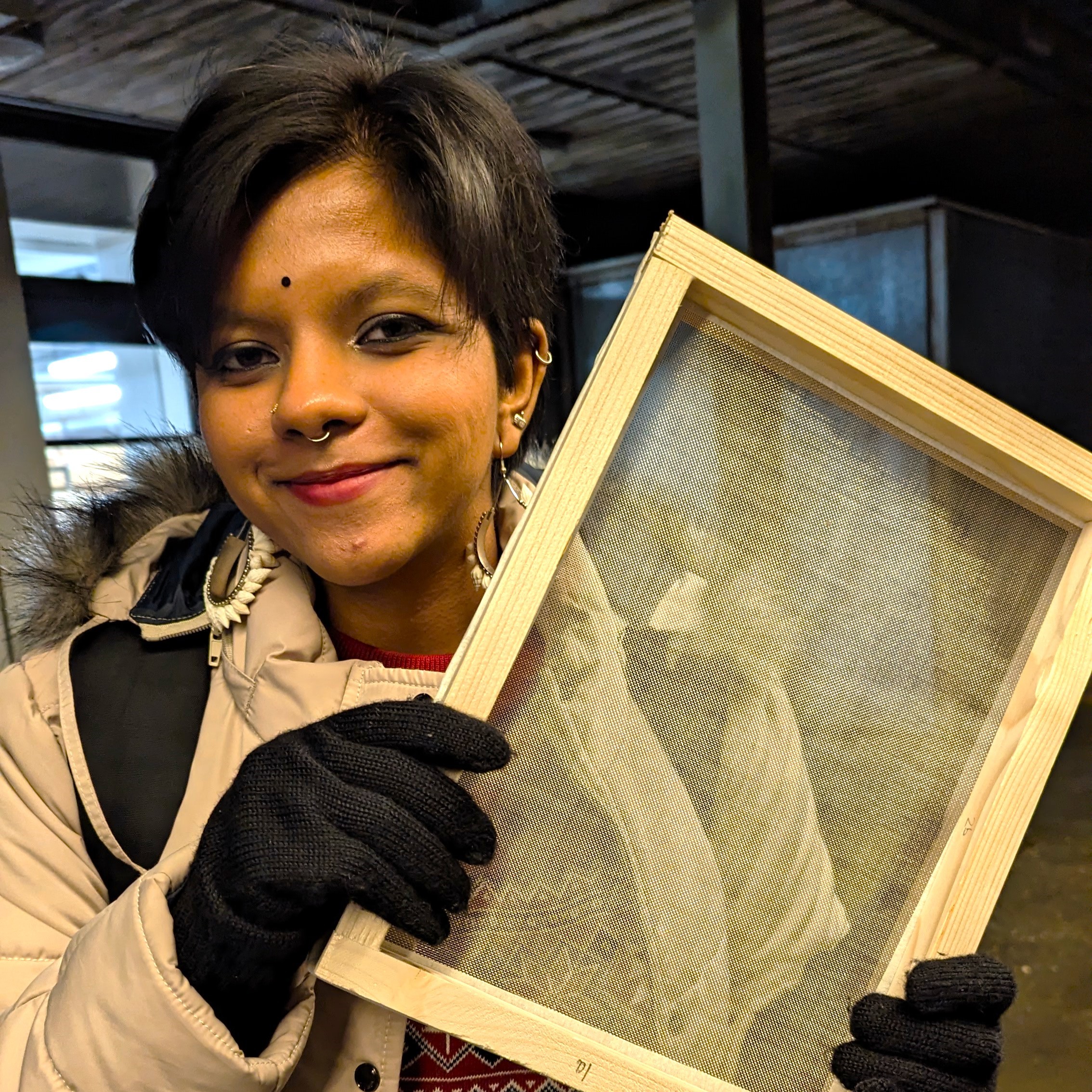 MA Graphic Design A. Ganesh holding a deckle and frame.