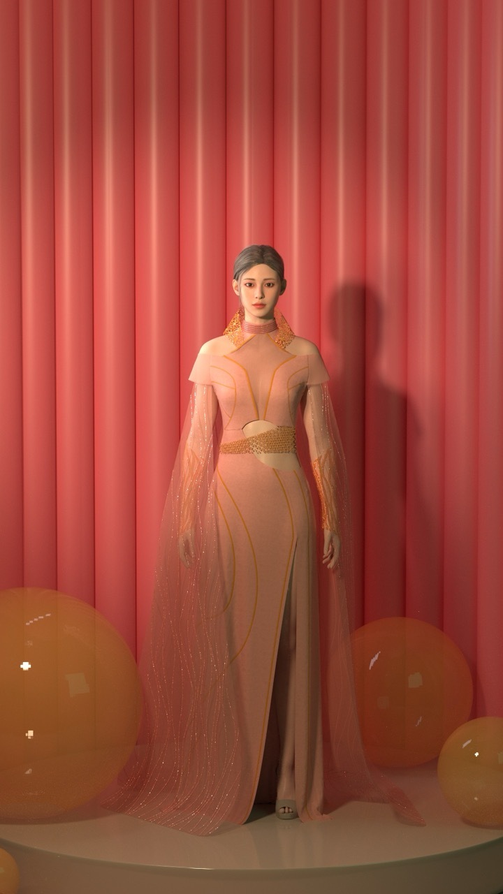 Woman in pink evening gown with gold jewellery standing against coral curtain backdrop with balloons on floor.