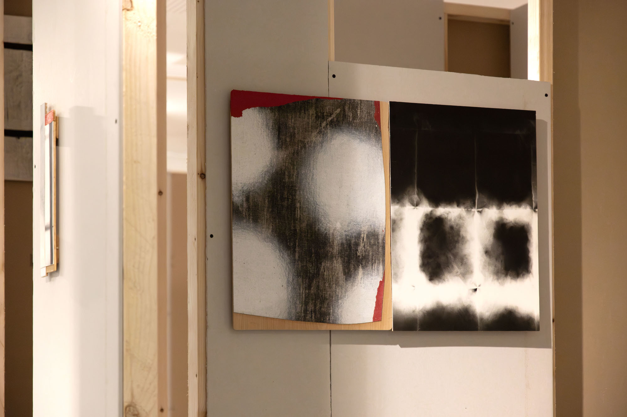 Two abstract pieces of artwork on canvases displayed in TheGallery at AUB.