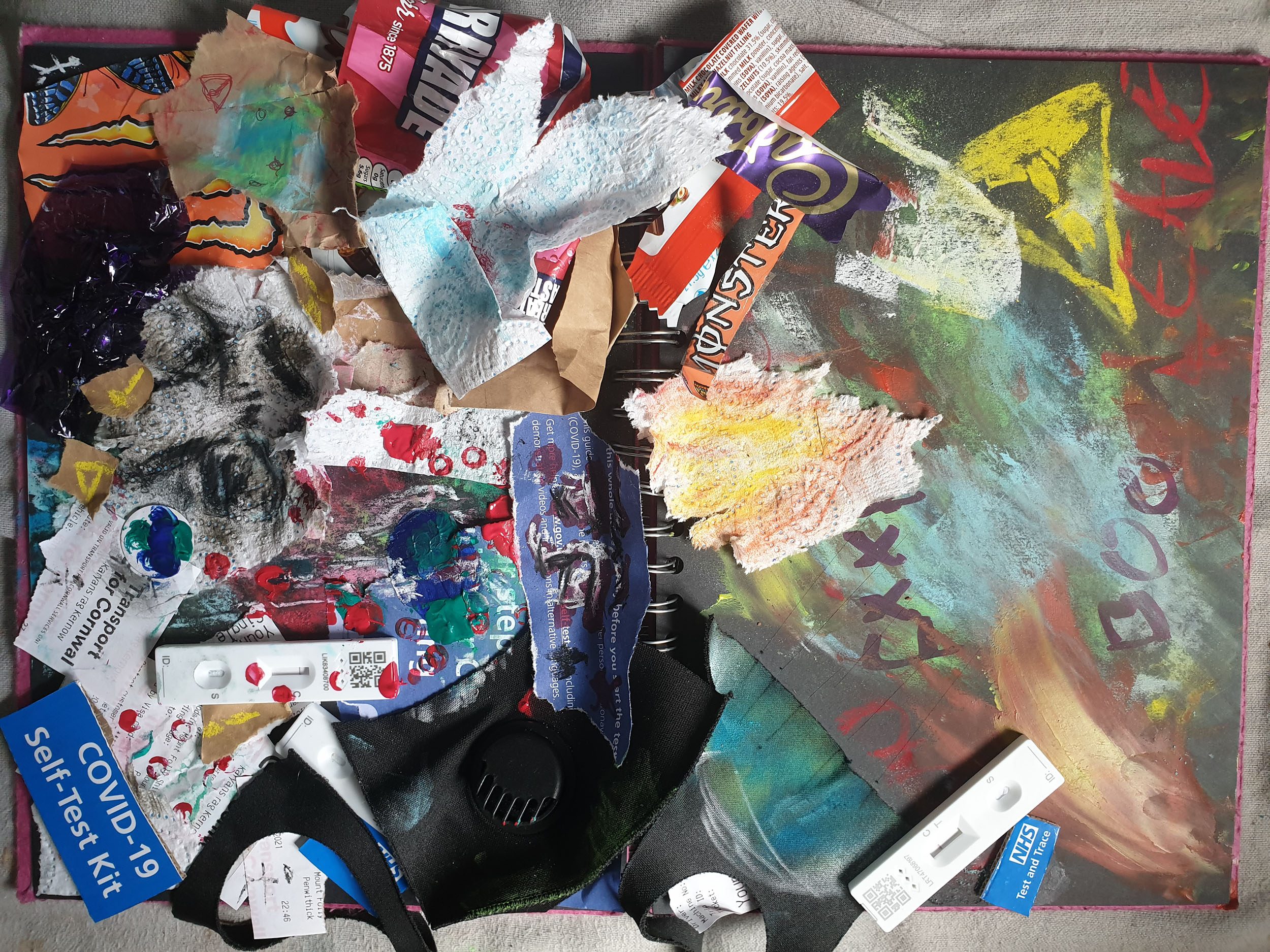 Image of a painted canvas with used packaging materials on top
