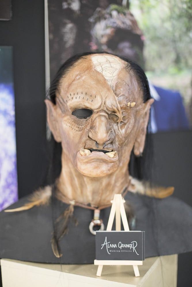 Bust with a facial prosthesis on it, designed to look like an orc.