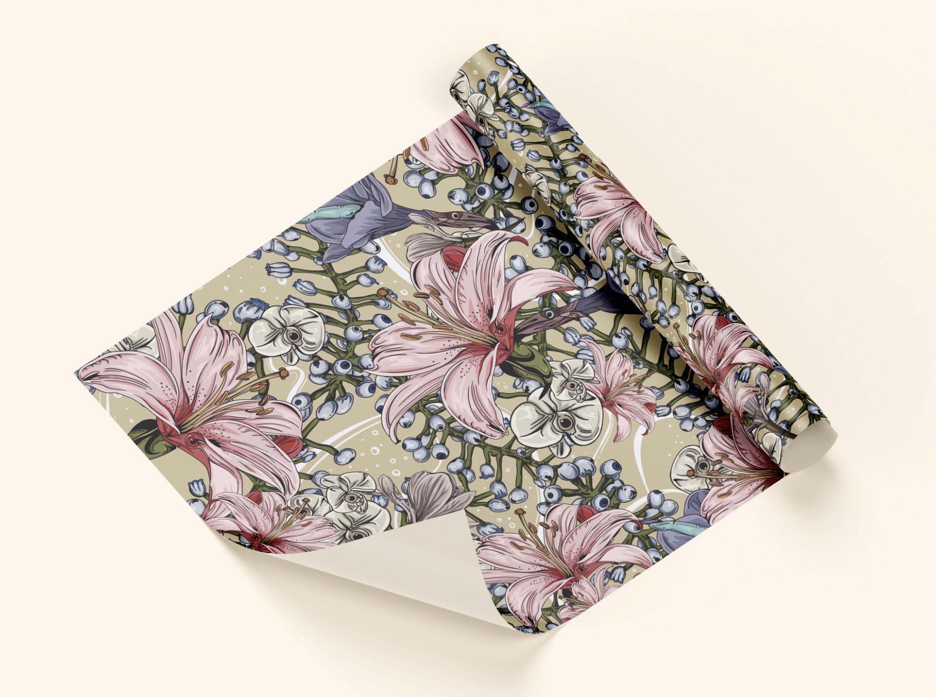 A folded sheet of floral wrapping paper with pink lilies and blue berries on a cream background.