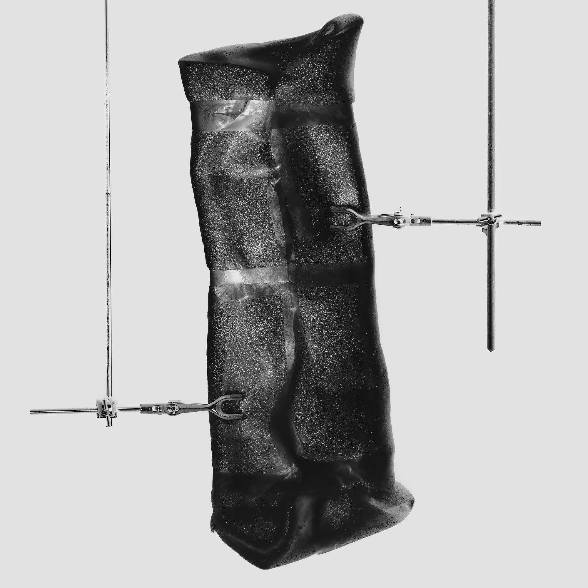 A black polyethylene back held in place by two thin clamps.