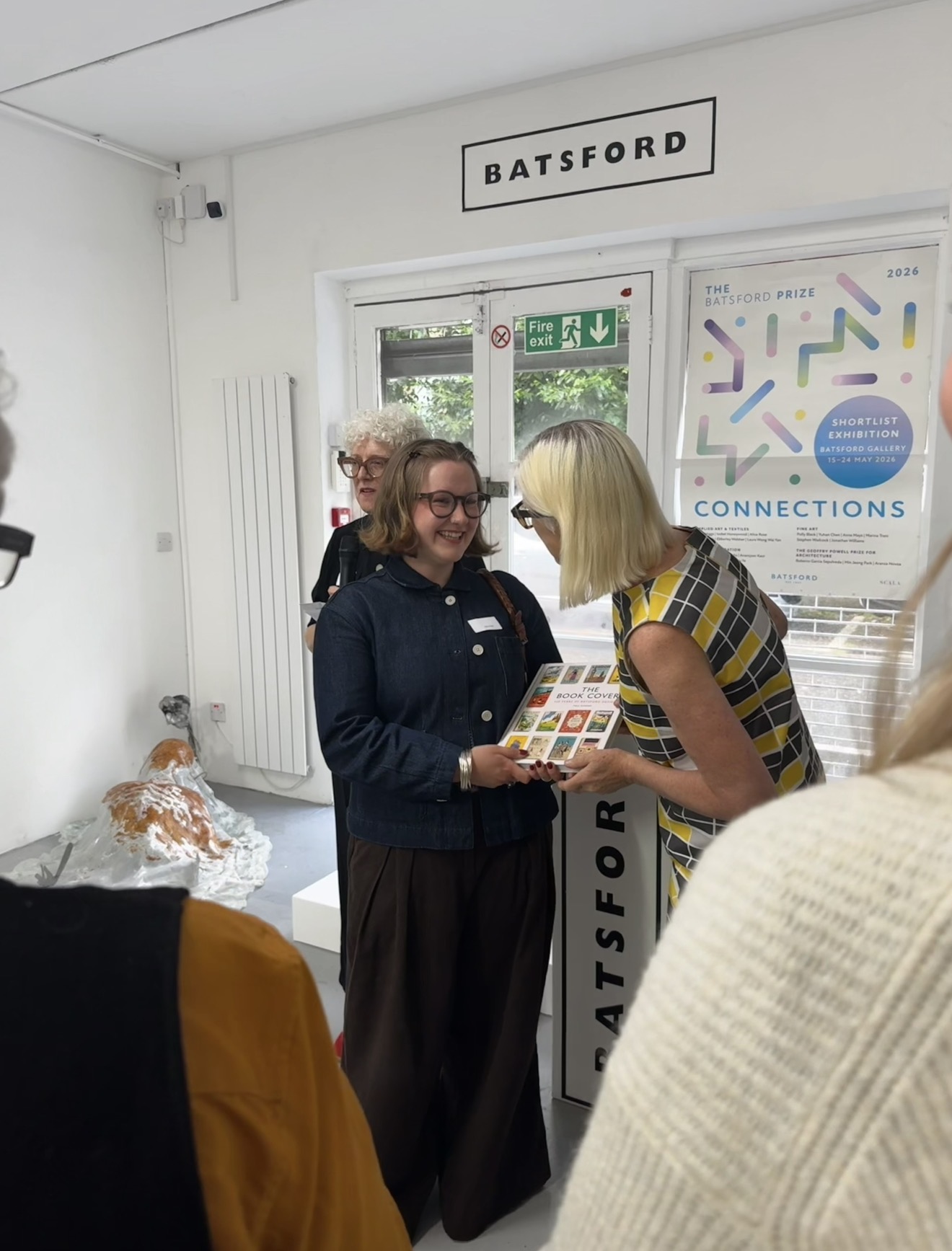 BA (Hons) Textiles Design student A. Rose being handed "The Book Cover" at a Batsford Prize ceremony