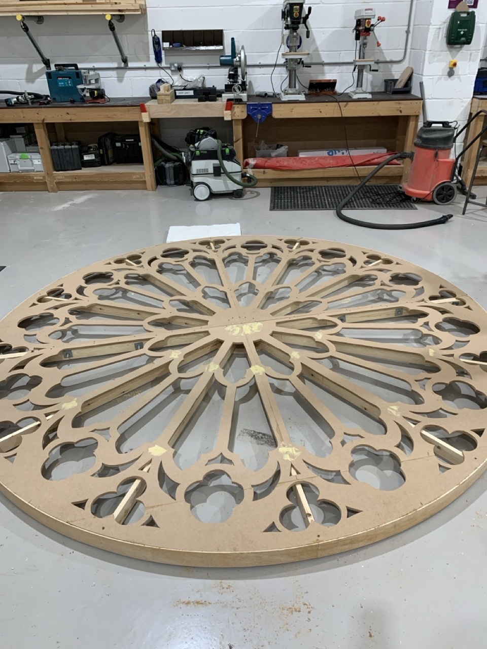 Large, round wood stained glass window in a workshop for AUB Productions' 'I, Joan'.