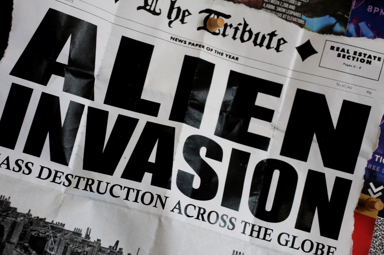 Close-up of the top of the newspaper cut out, showing the headline, subheading and the name of the newspaper “The Tribute”.