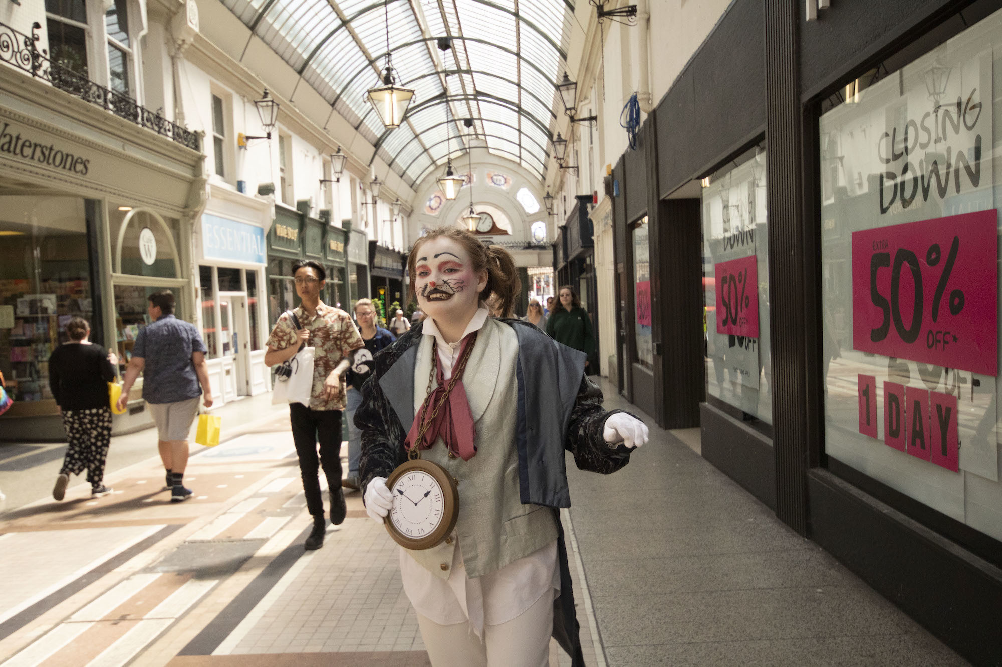 Person in costume as the White Rabbit from Alice's Adventures in Wonderland standing in a Bournemouth shopping arcade.
