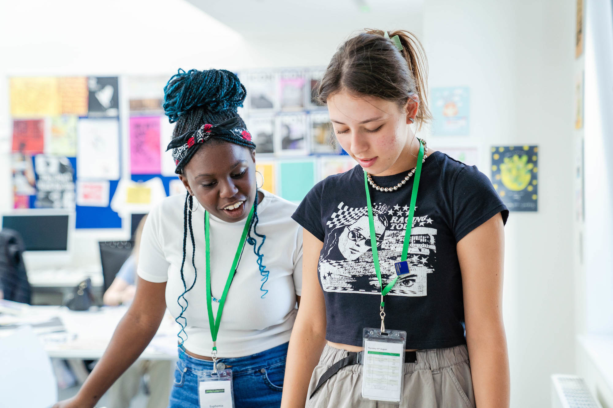 An AUB Access and Participation outreach ambassador standing next to a residential attendee during a workshop.