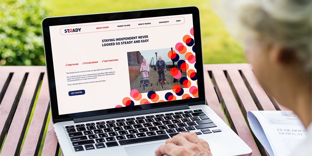 An older adult looking at the Steady website page which reads ‘staying independent never looked so easy’.