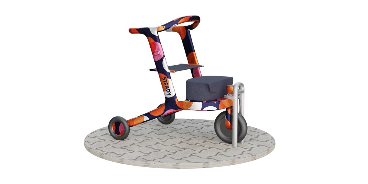 A colourful spotty mobility aid docked onto a trombone-style stand.