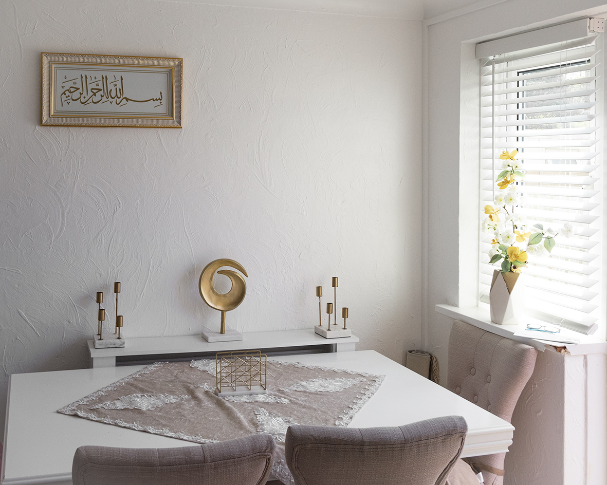 Dining room table and chairs with sunlight coming through the blinds