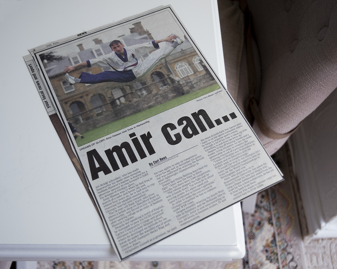 News article with a younger Amir doing jumping splits in the air