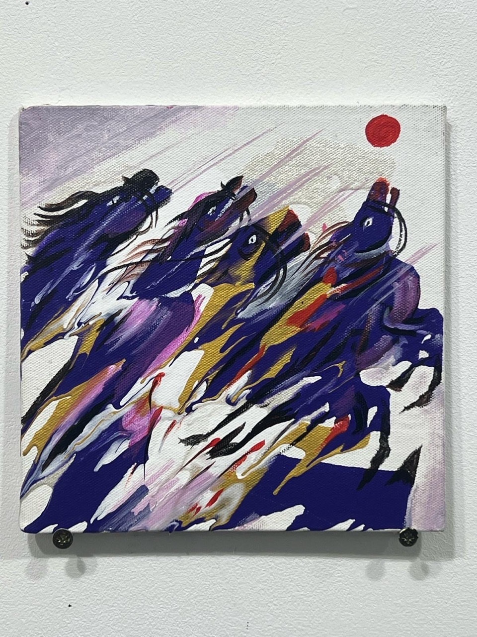 Abstract painting of purple and yellow dragons in motion with a red sun, as part of Ananta's exhibition.