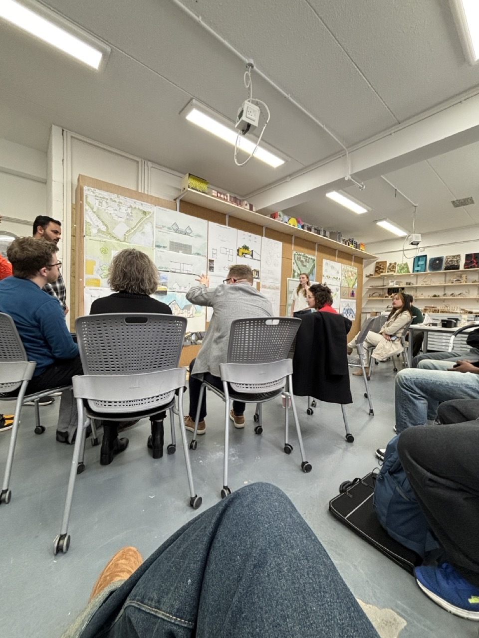 Students sat in an architecture talk looking at work on cork panelling.