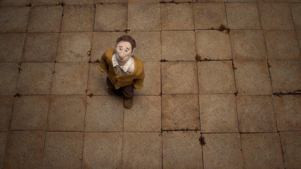 Animated still of a man standing on a tiled floor looking up.