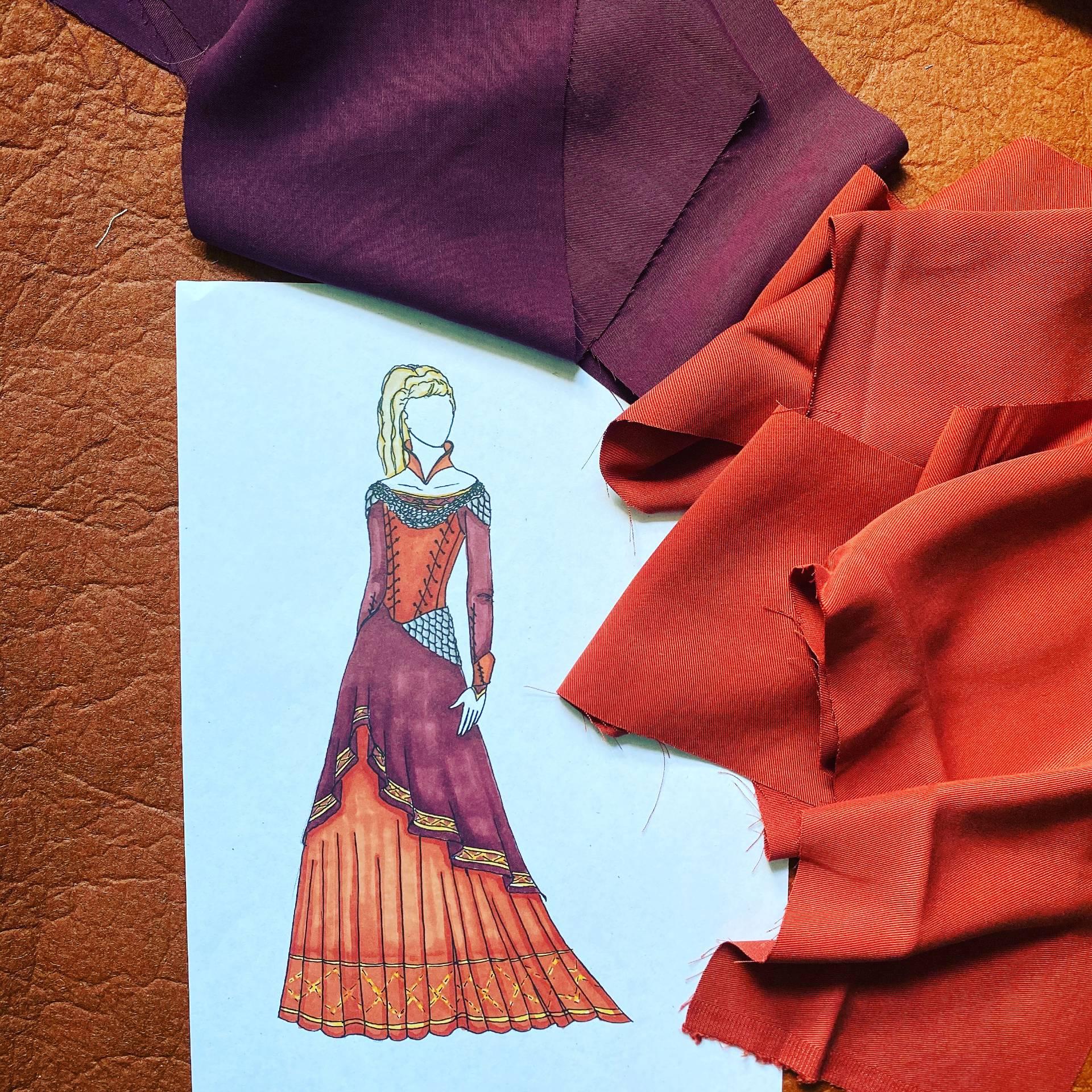 Coloured sketch of a person in a red multi-layered dress with fabric samples lying on the paper.