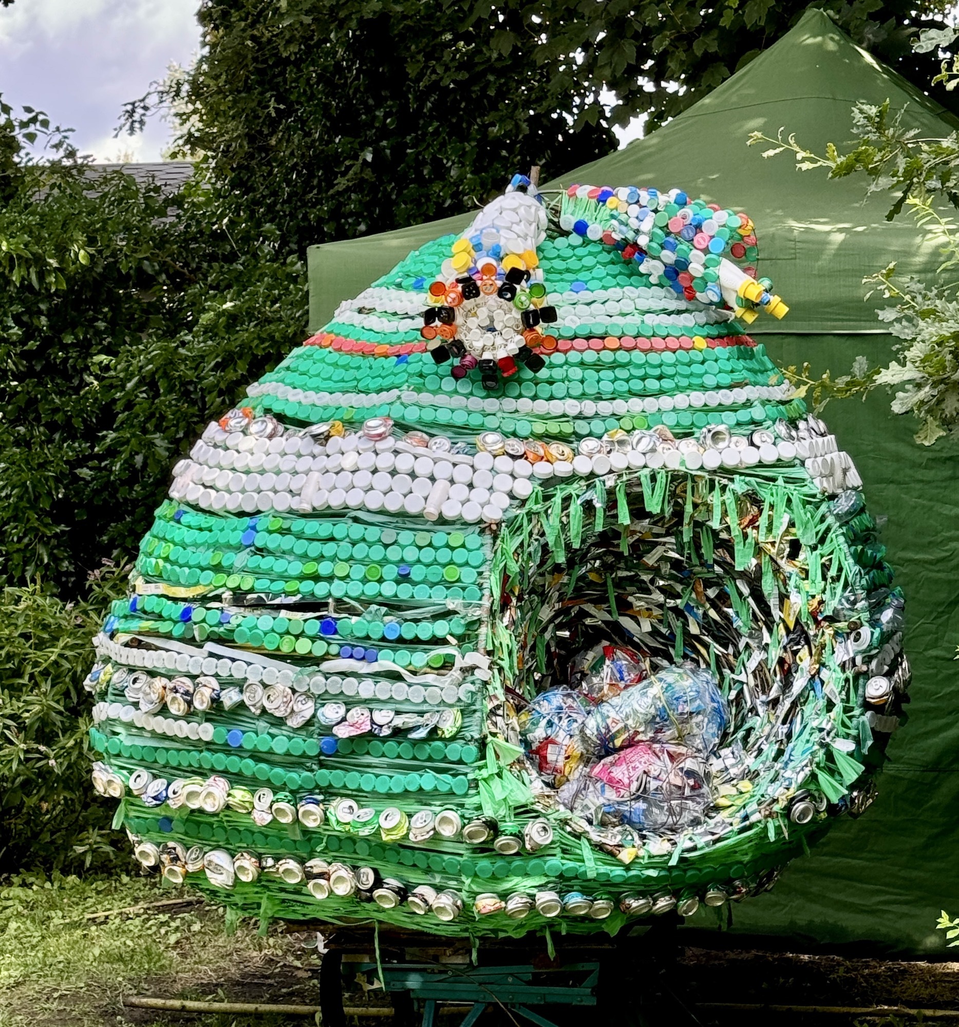 The completed sculpture "The Anthropogenic Nest" on display in a garden.