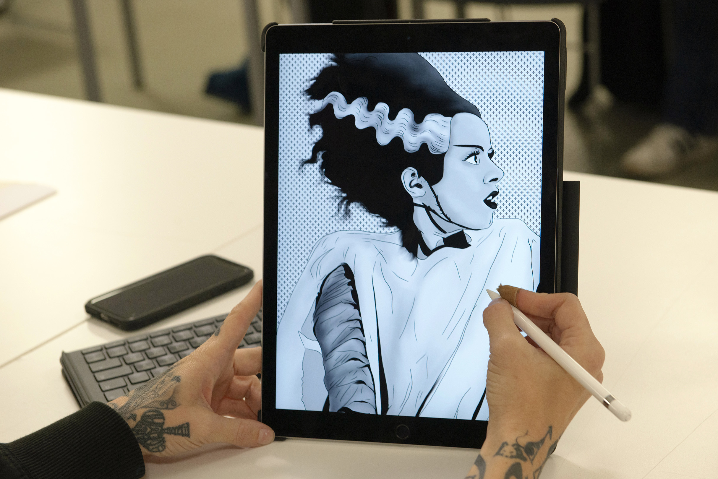 A student is digitally illustrating the bride of Frankenstein
