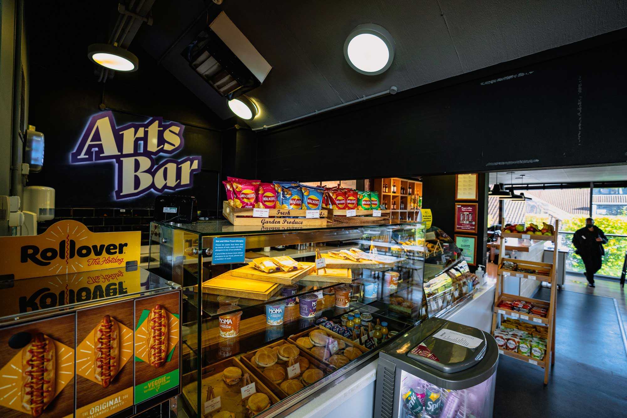 Arts Bar counter with hotdogs and snacks on display