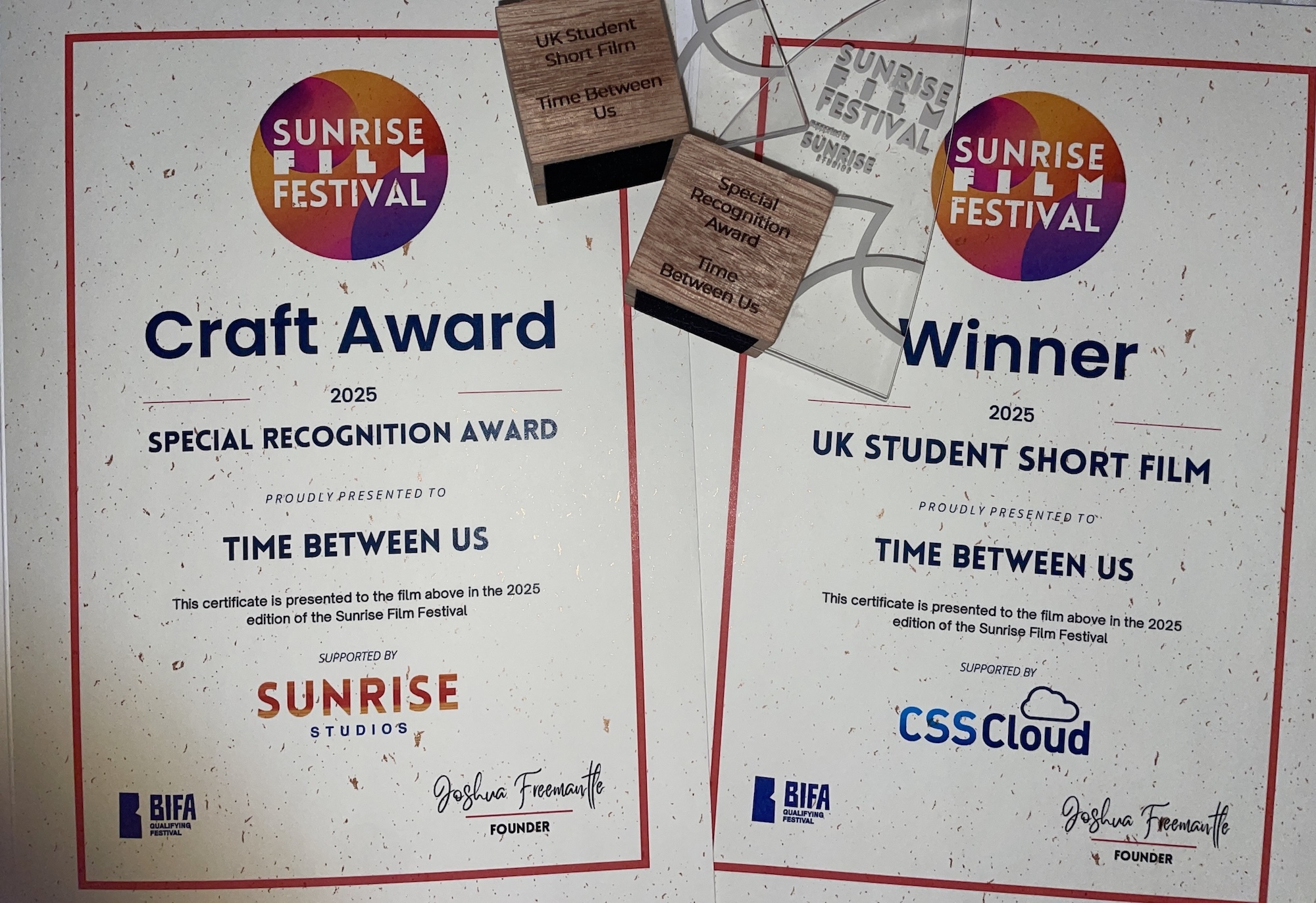 Two white certificates with red borders and colourful circular logos. Left shows "Craft Award" for special recognition, right shows "Winner" for UK student short film. Both awarded to "Time Between Us" from Sunrise Film Festival 2026.