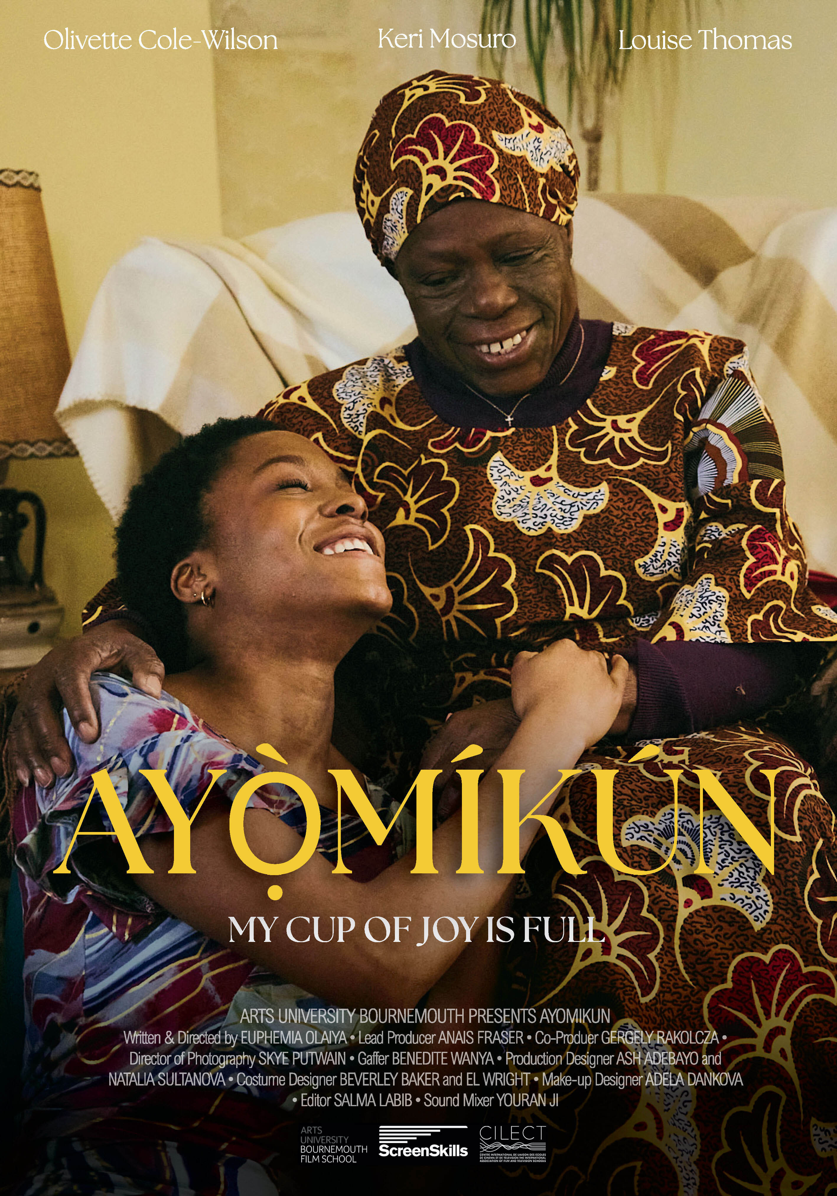 Film poster showing two smiling women embracing. One wears colourful African-patterned clothing with matching headwrap, the other in light blue. Golden title "AYOMIKUN" below with cast and crew credits at bottom.