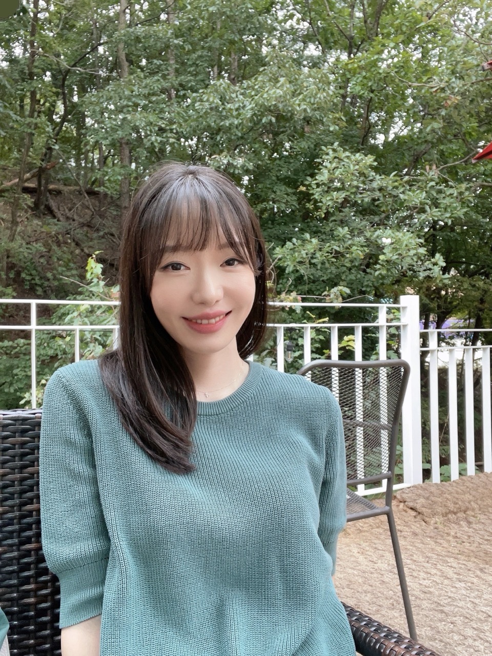 Photo of Ayoung Choi with a forest in the background.