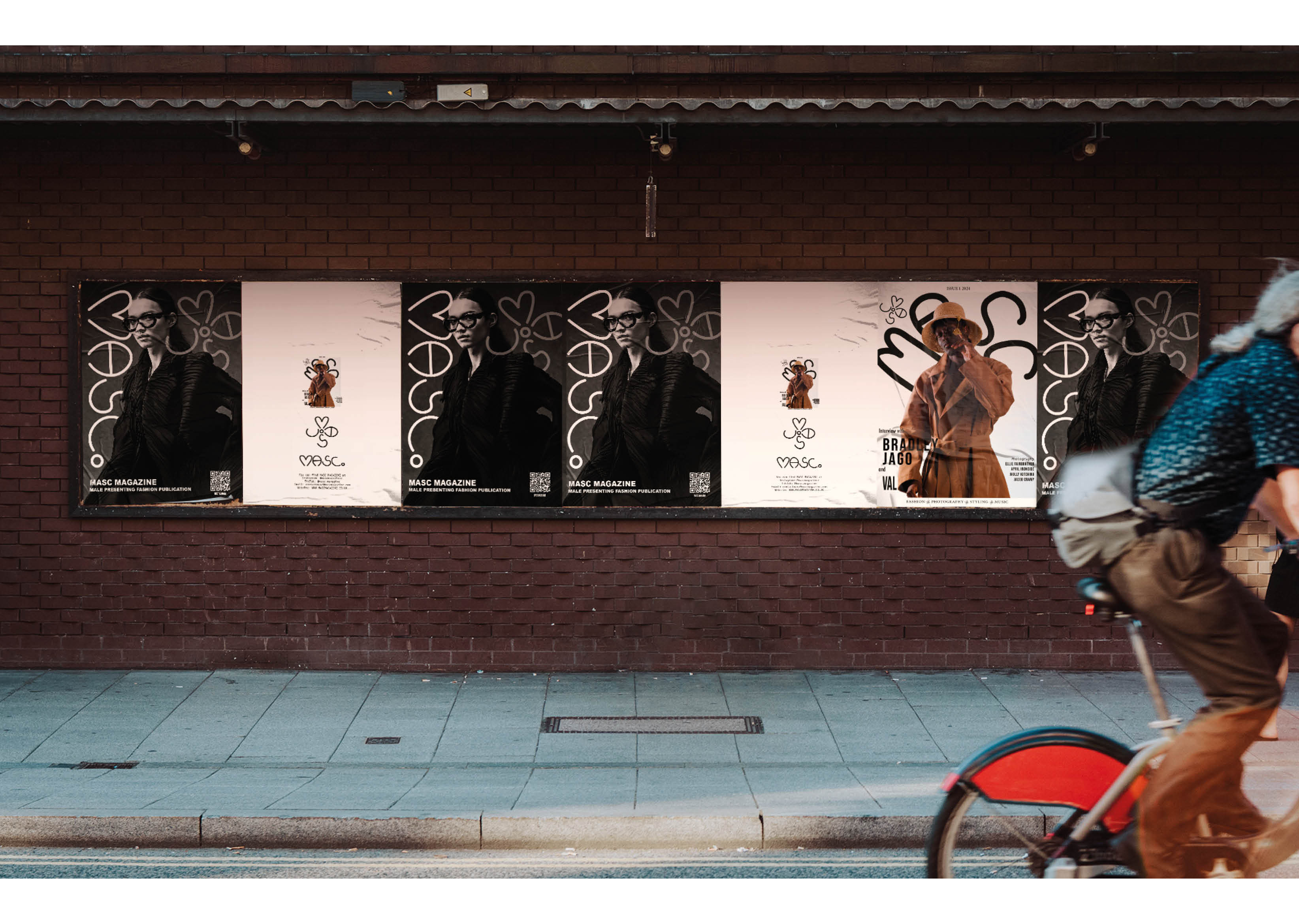 A long landscape billboard on a brick wall showing various posters for MASC Magazine.