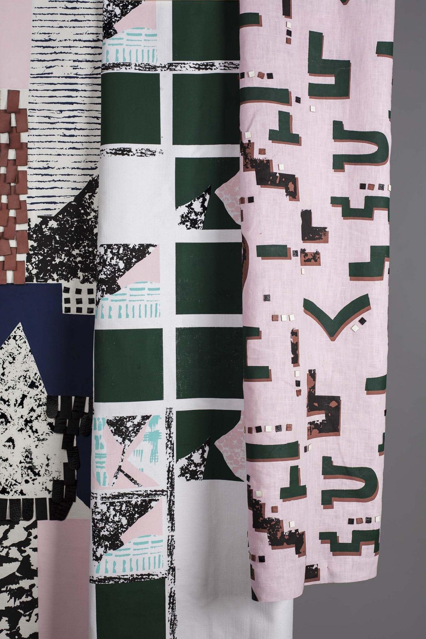 Three rolls of fabric with different patterns.