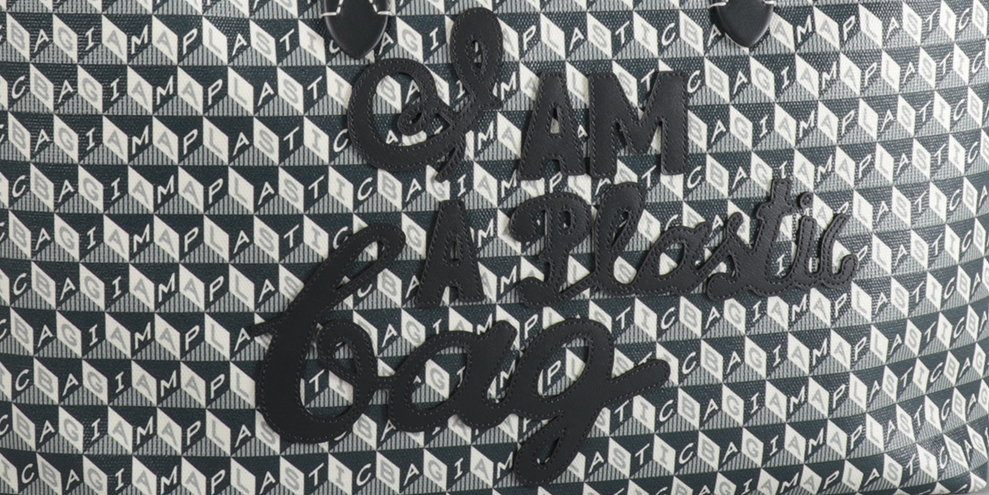 Black cut-out Arabic lettering layered over a grey geometric patterned background.