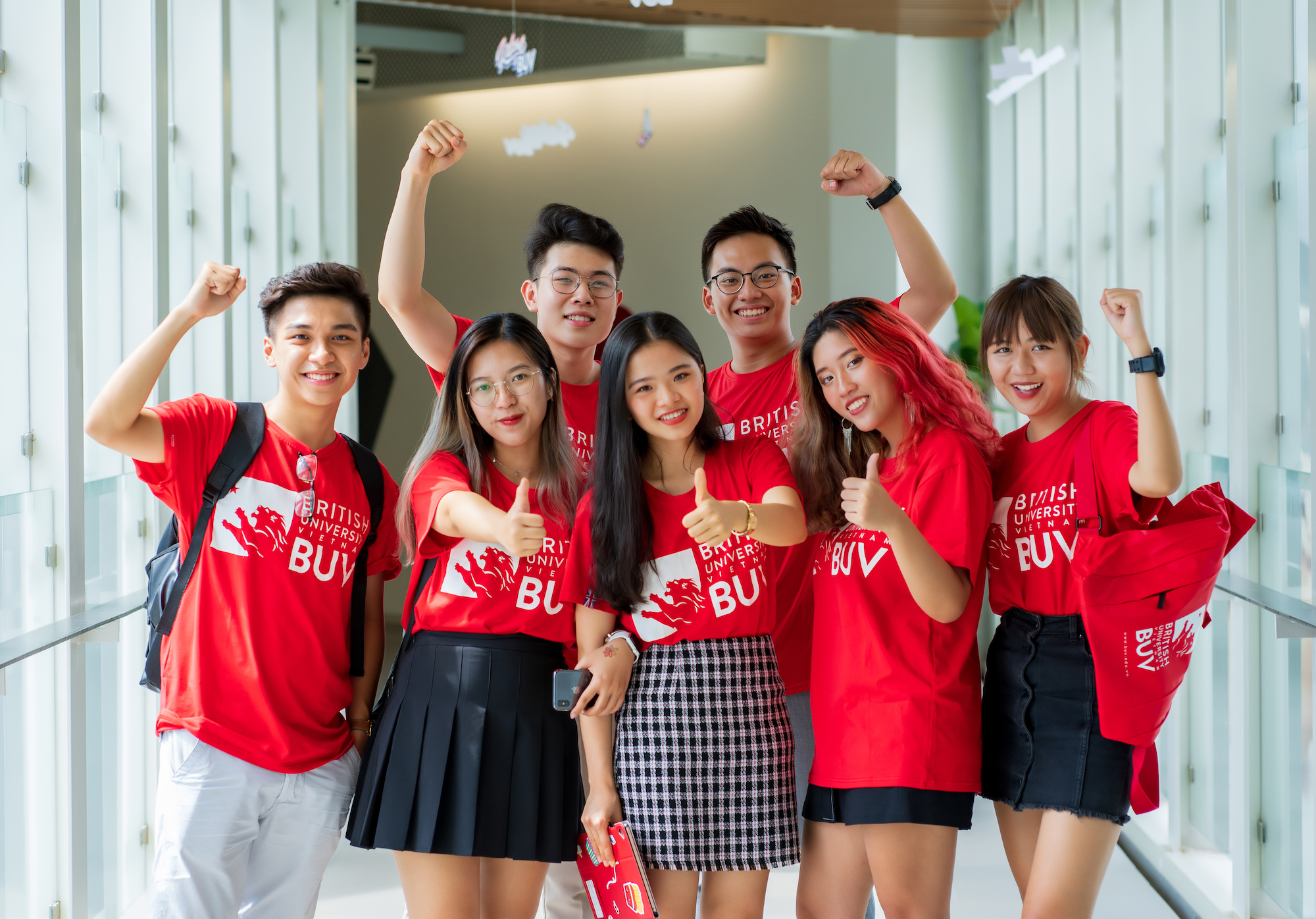 A group of students pose for a photo wearing BUV T-shirts.