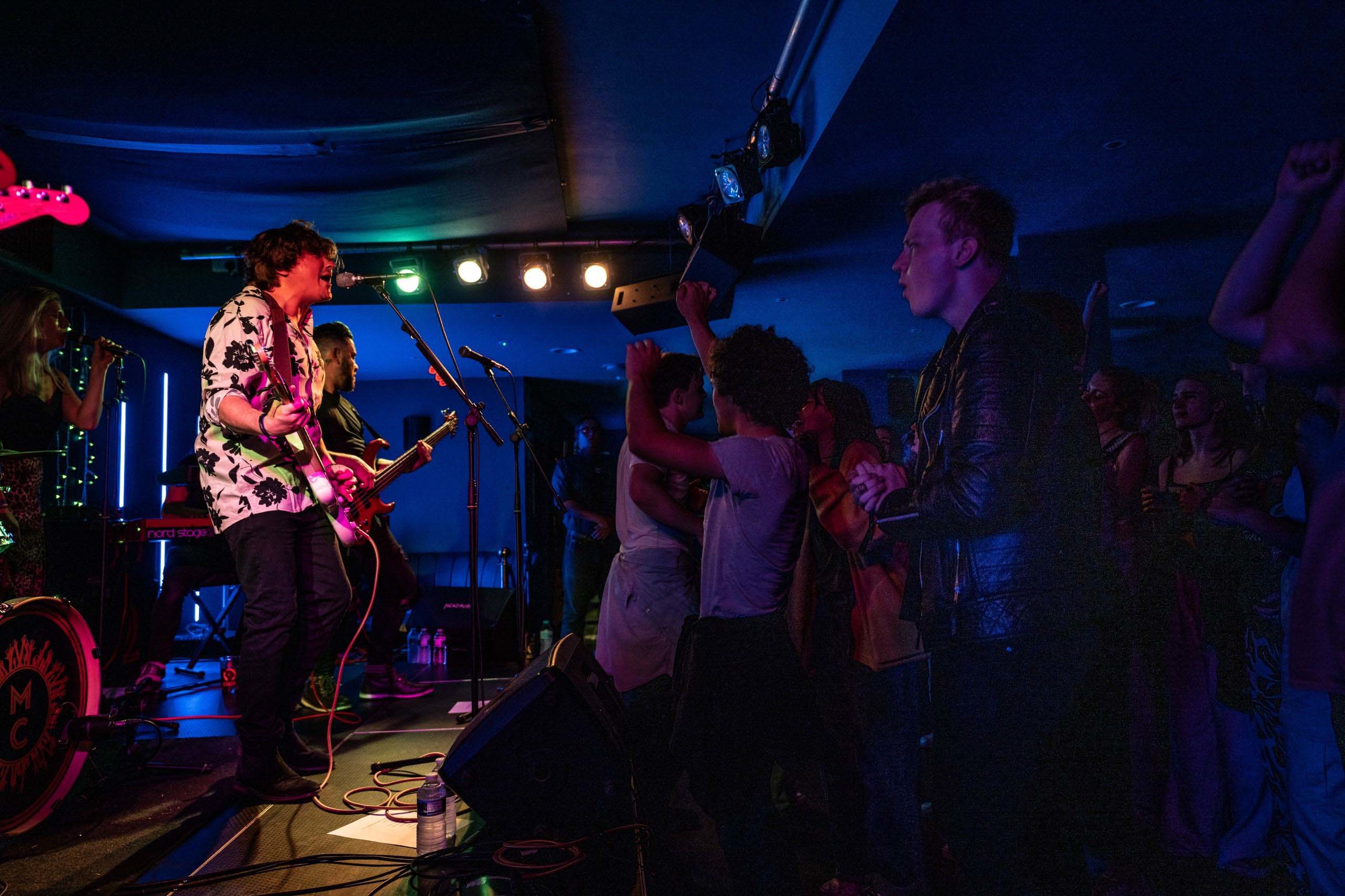 Musicians playing to an excited crowd at the Madding Crowd venue
