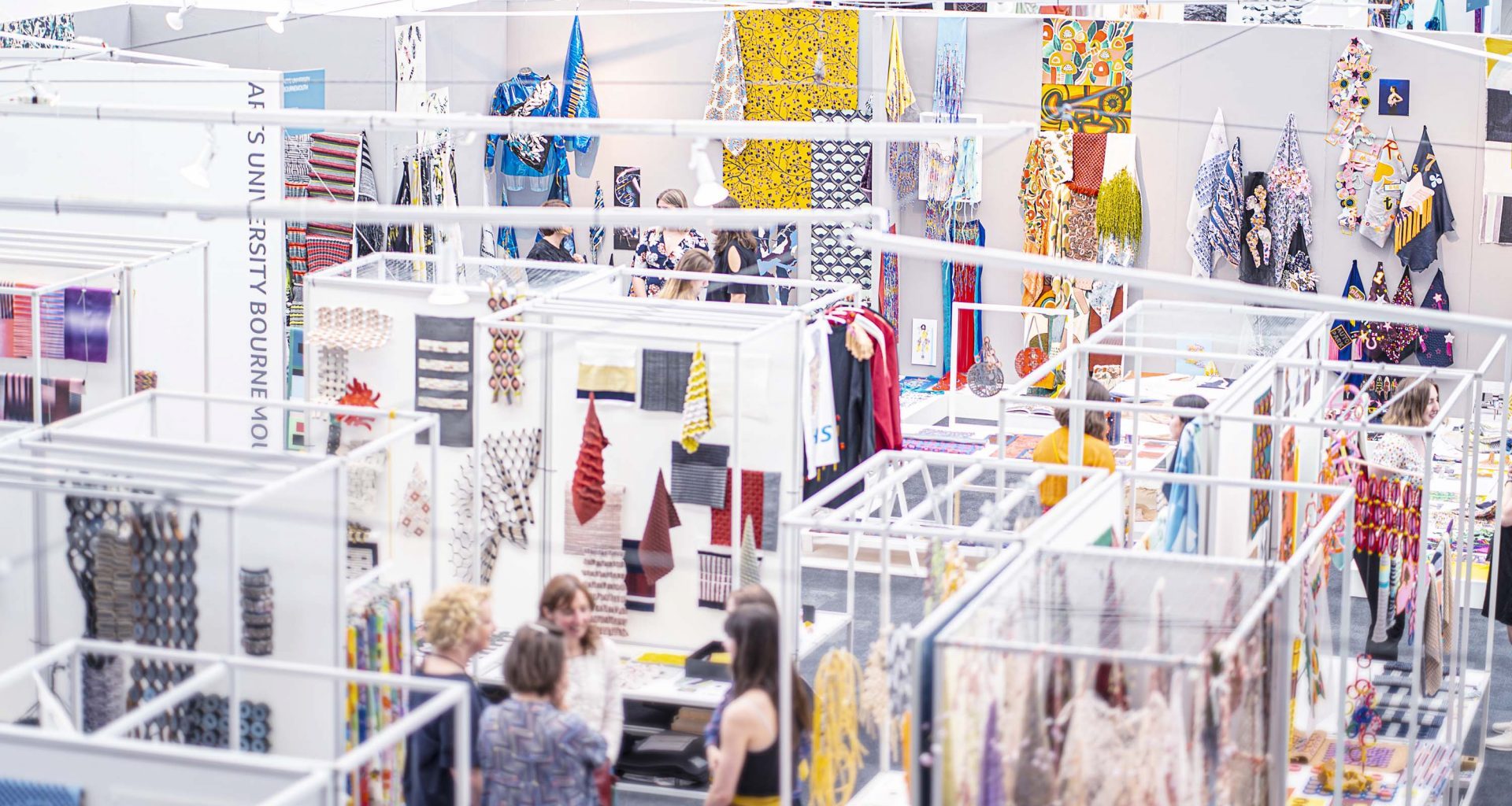 Overhead view of a textiles exhibition in a gallery space.