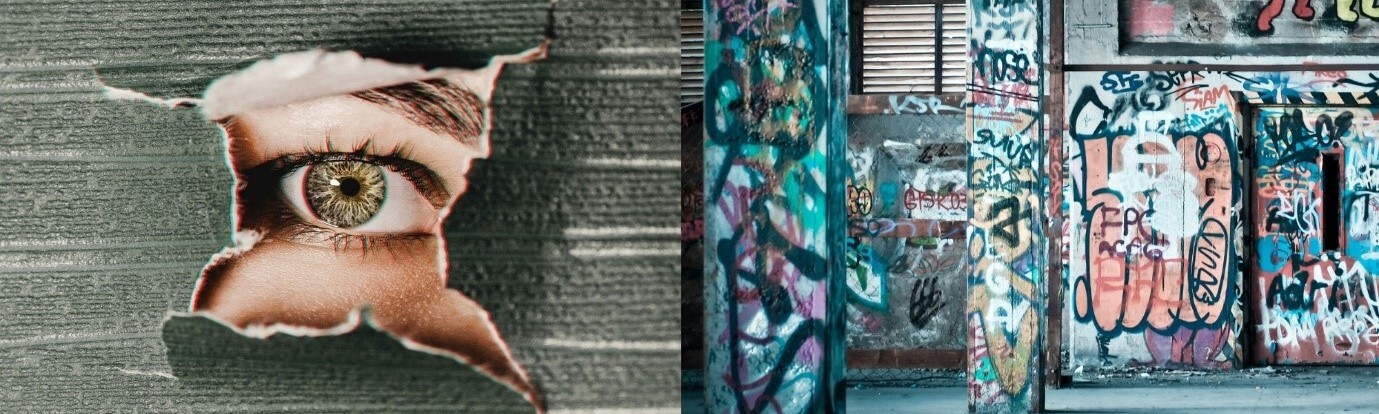 Torn poster showing close-up eye on brick wall next to colourful graffiti-covered utility boxes and shuttered storefront.