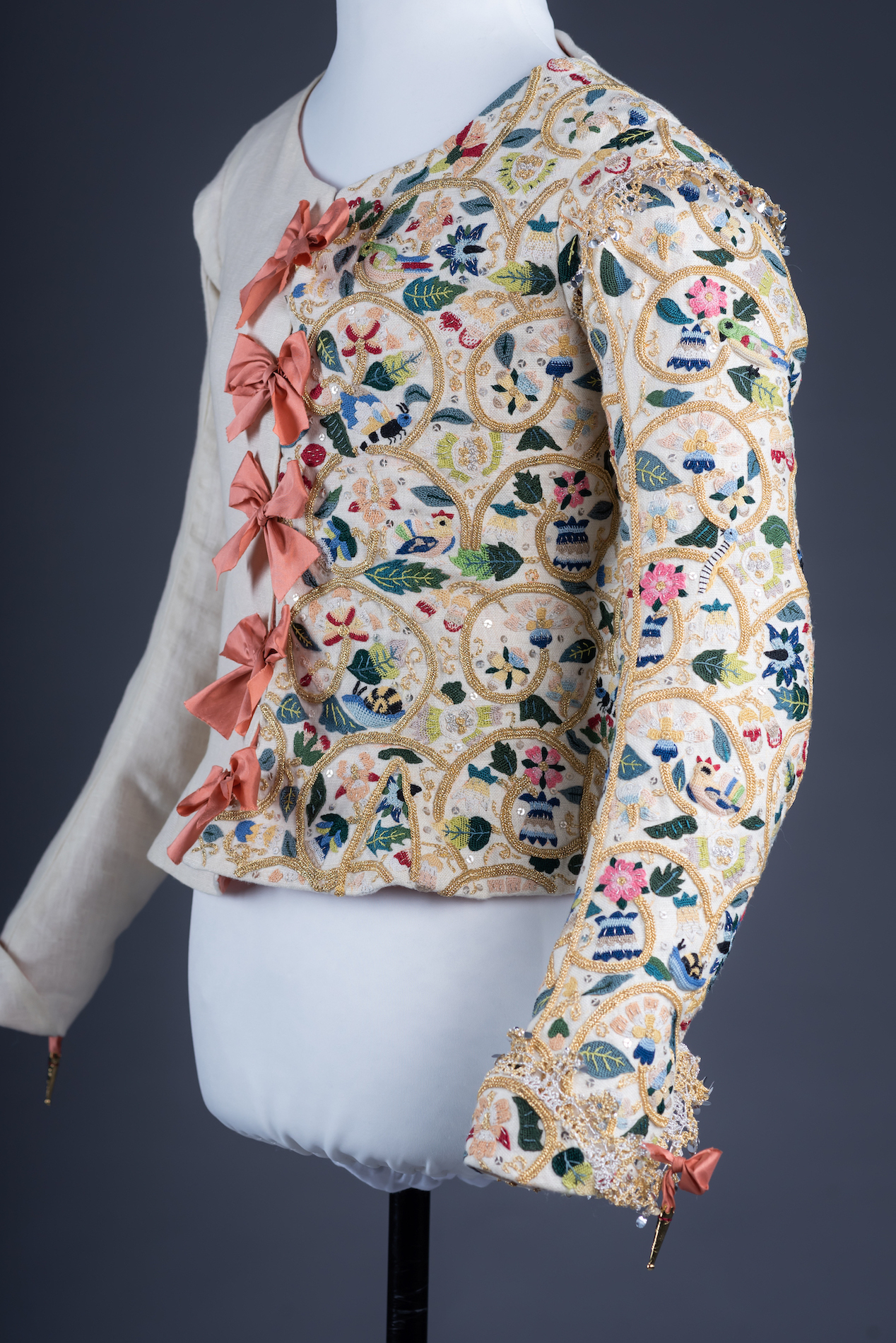 A 17th century jacket embroidered on one side with an intricate floral pattern.