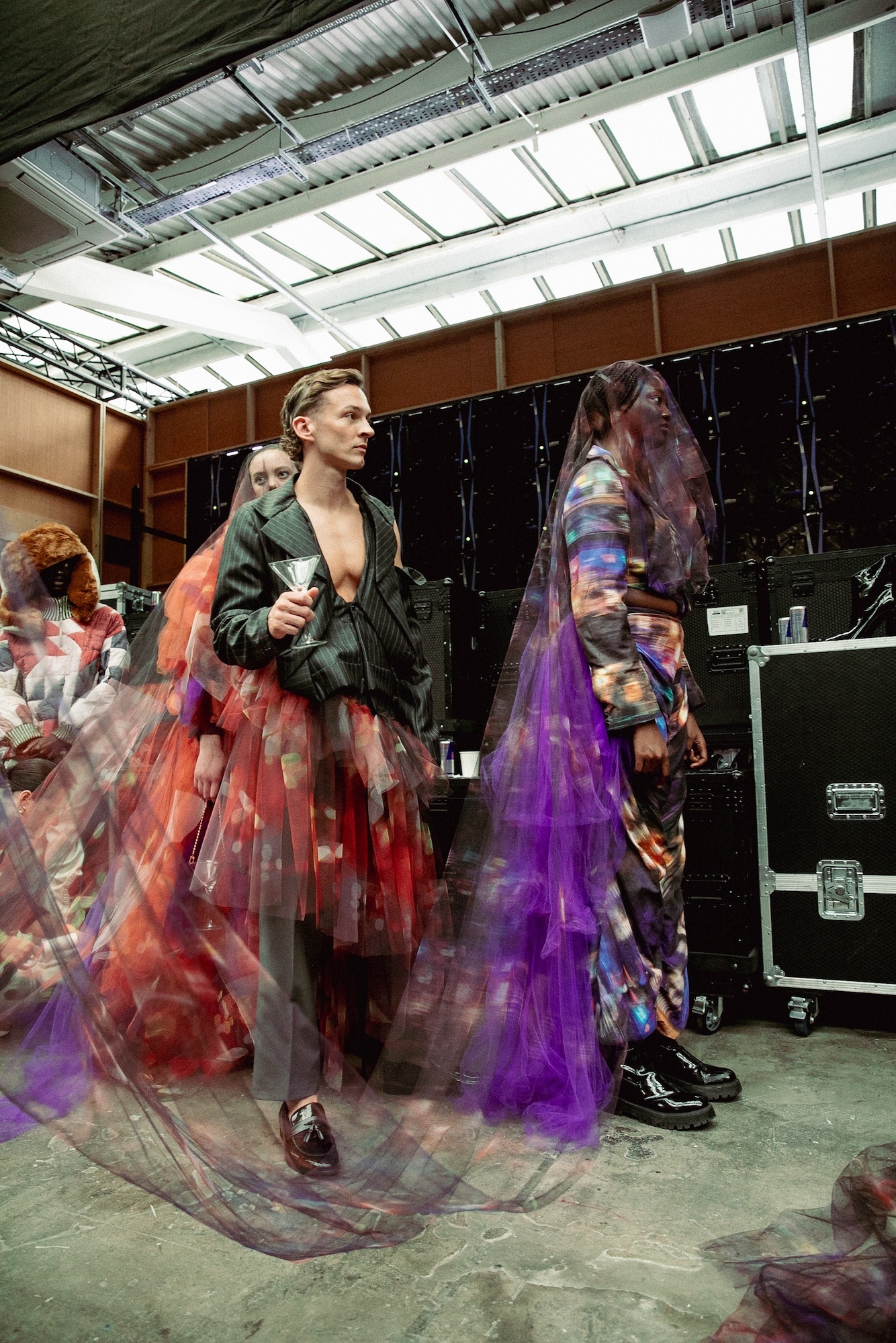 Models waiting backstage at GFW 2024 while wearing garments from the collection "Happy Hour" by J Mitchener.