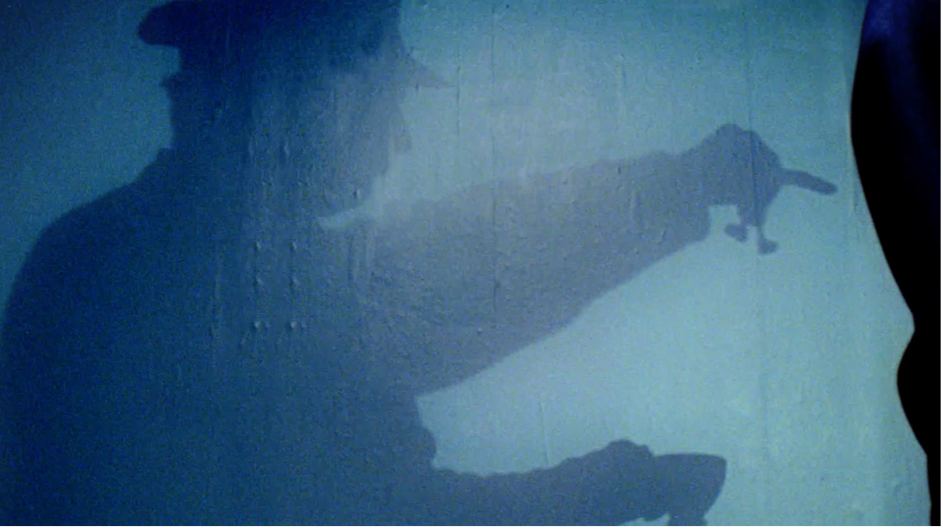 Still from BA (Hons) Film Production student commercial "Breaking Point", showing a silhouette of a man in uniform holding an unidentified object.