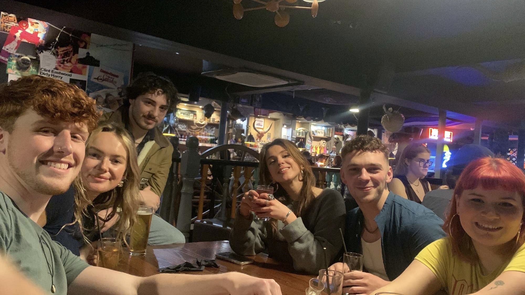 A group of six AUB students posing for a photo at a pub