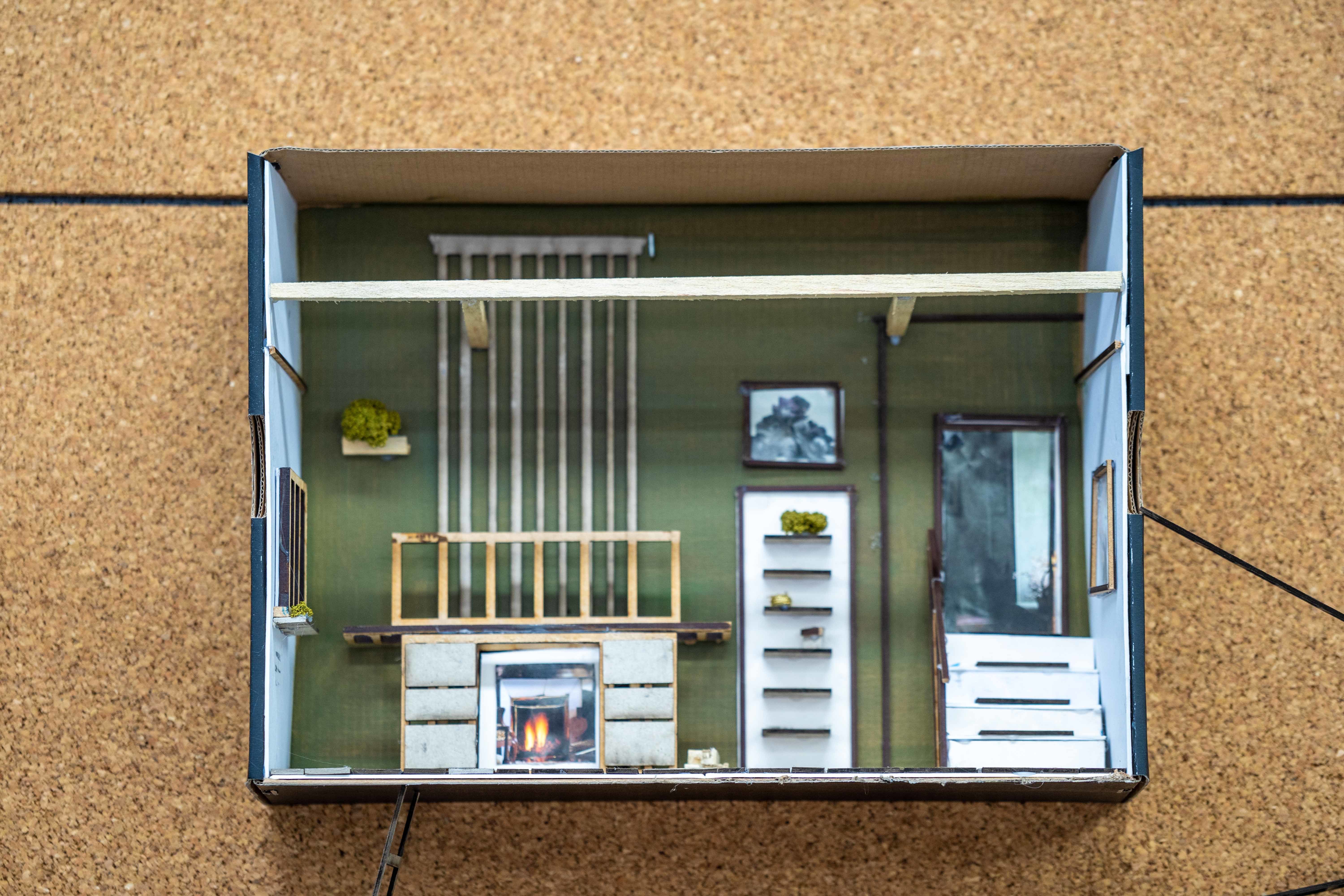 A shoebox decorated to represent a home environment