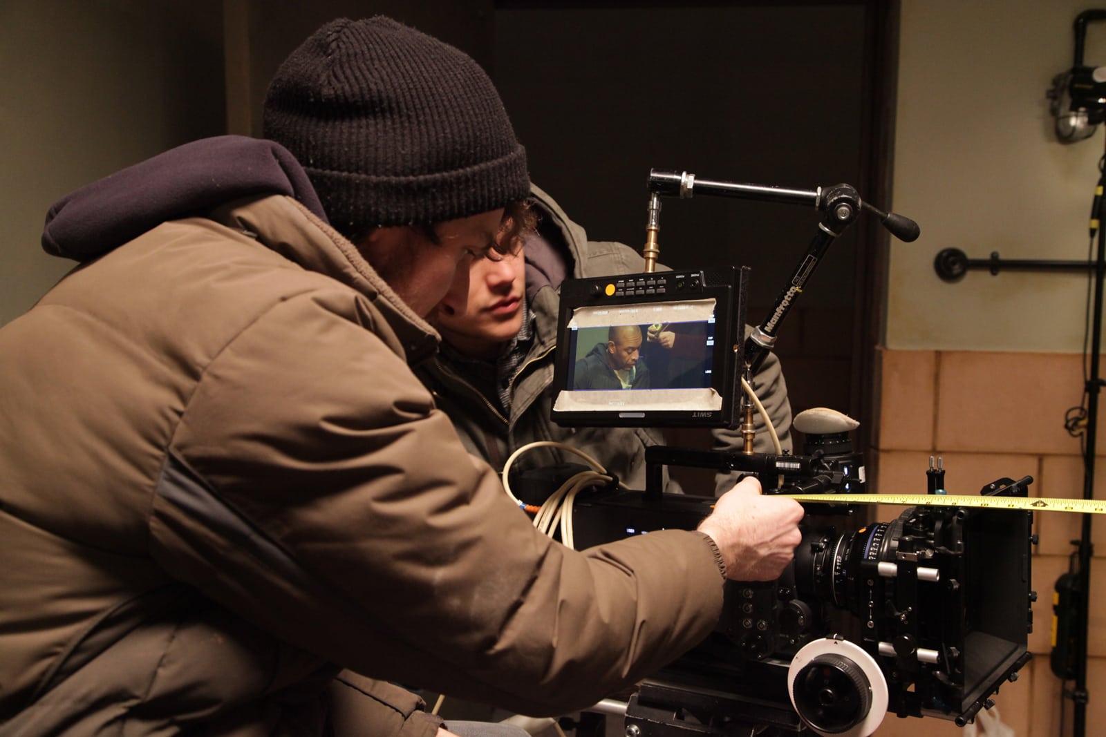 Student checking the focus on a camera whilst on a shoot