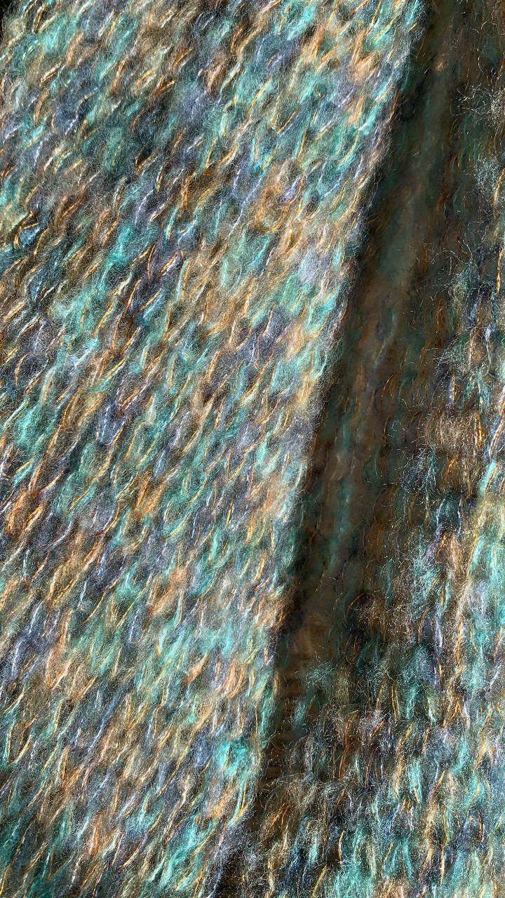 Close-up of a blue, orange and purple wool garment.