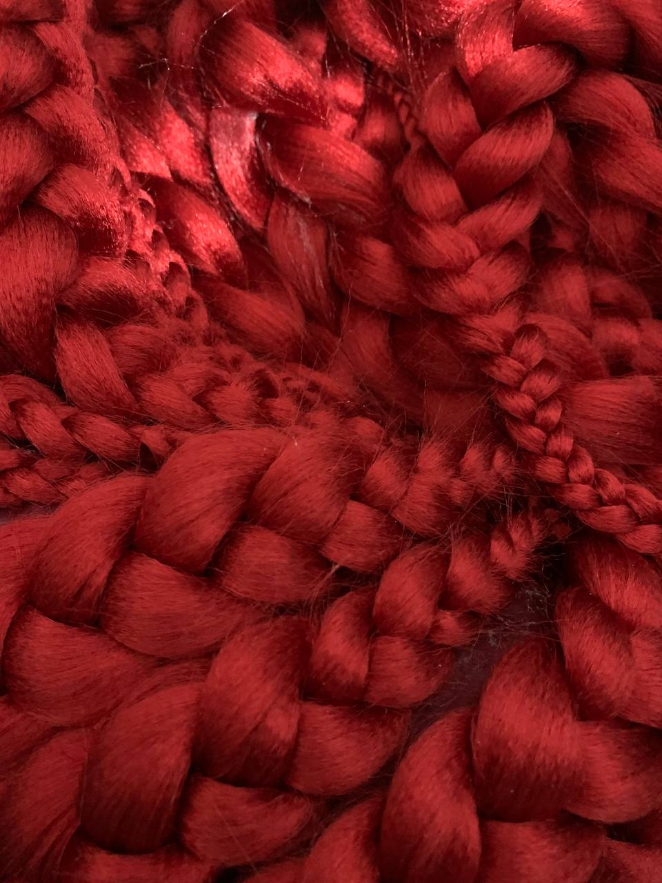 Close-up of several red hair braids.